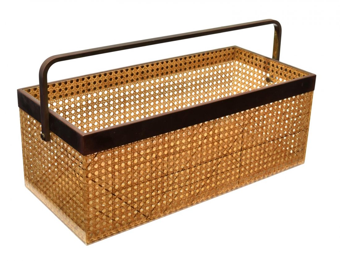 ITALIAN DESIGN PLEXI & CANE HANDLED MAGAZINE RACK: Italian design plexi clad caned magazine holder, having metal rim and handle, 8"h, 21"l, 9.5"d, 11lbs Start Price: $60.00