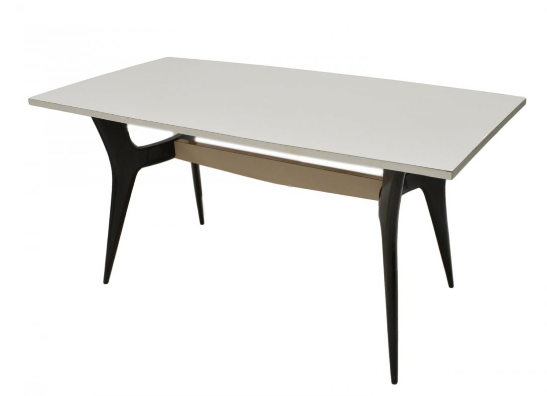 ICCO PARISI (ATTRIB) ITALIAN MID-CENTURY TABLE: Italian mid-century modern dining table, design attributed to Icco Parisi (Italian, 1916-1996), the shaped white laminate top rising on angled ebonized supports, some lifting at top, one corner with s