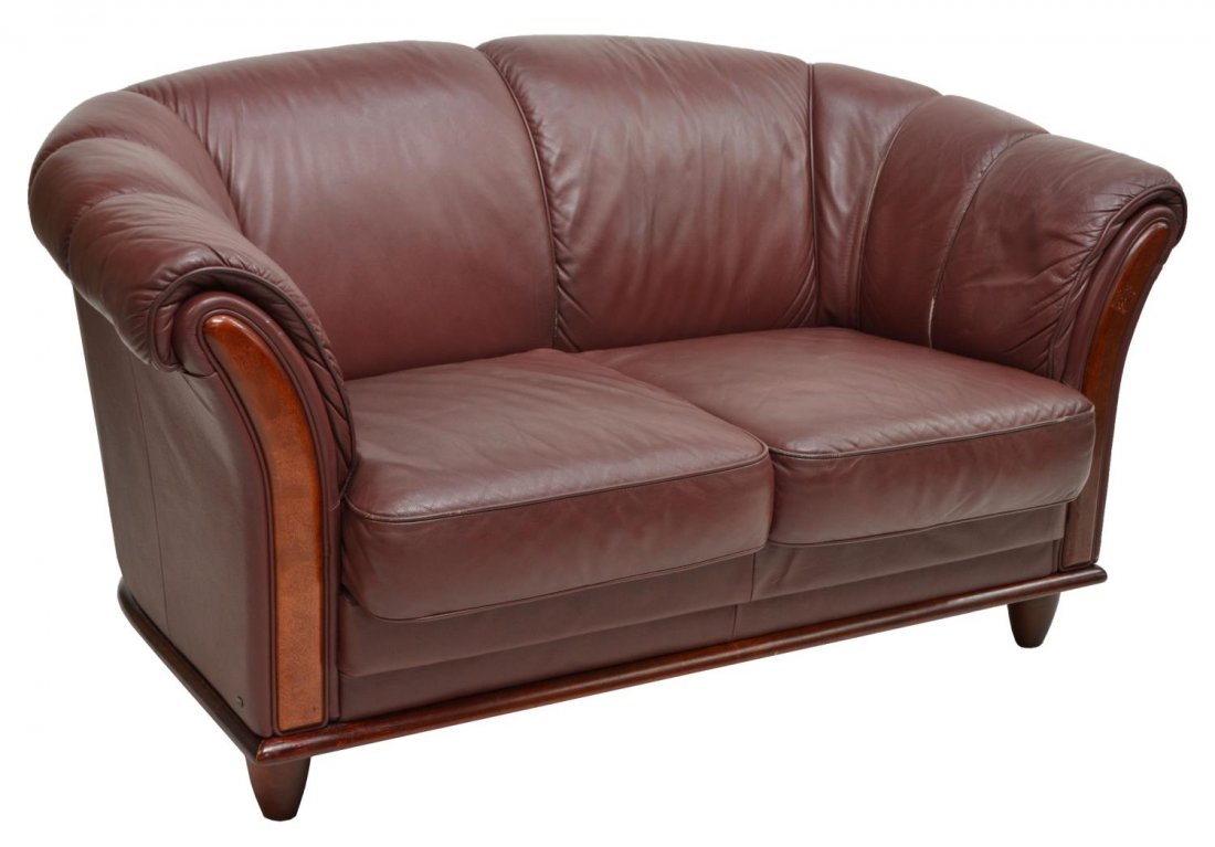DANISH MODERN BURGUNDY LEATHER LOVESEAT, C. 1970: Danish modern burgundy leather two-seater loveseat, c. 1970s, the curved back sloping down into the padded armrests, with cord detail, rising on short tapered legs, 31"h, 56"w, 33"d Start Price: $150.