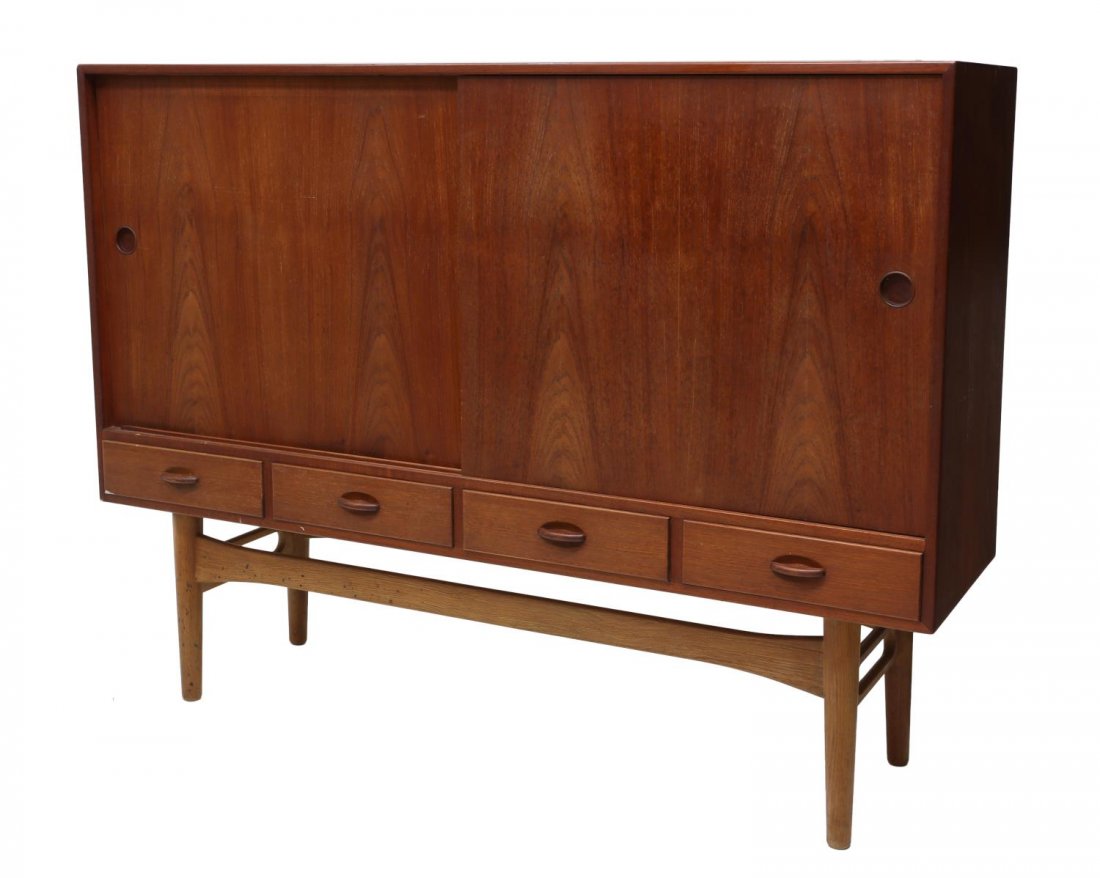 DANISH MID-CENTURY MODERN TEAKWOOD SIDEBOARD: Danish mid-century modern teakwood sideboard, c. 1950's/60's, two sliding doors open to shelved interior and display sections fitted with tray drawers, all over four drawers, raised on a stretcher bas