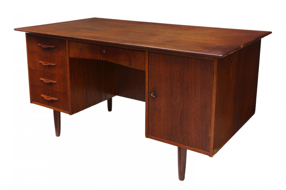 DANISH MID-CENTURY MODERN TEAKWOOD PEDESTAL DESK: Danish mid-century modern pedestal desk, c. 1950/1960, the rectangular case above a frieze drawer, fitted with four drawers and a door housing a shelved interior, rising on tapered legs, spots to top,