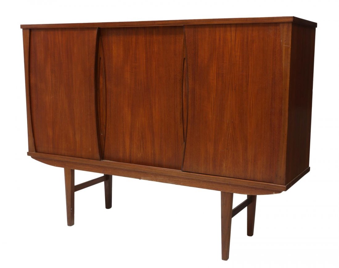 DANISH MID-CENTURY MODERN TEAK HIGH SIDEBOARD: Danish mid-century modern teak high sideboard, c. 1950s/1960s, the rectangular case with three sliding doors fitted with shelves and drawers, rising on cylindrical supports, 45"h, 75"w, 18"d Start Pri