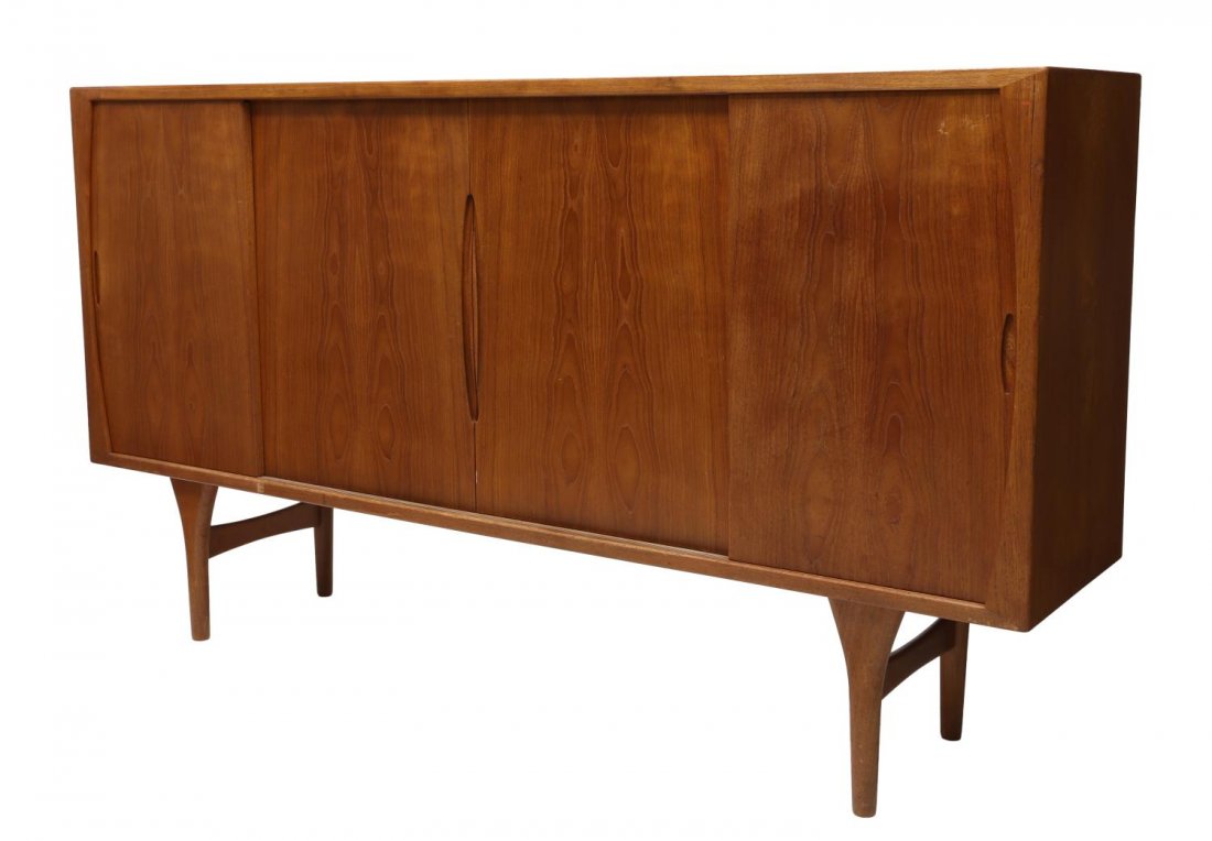 DANISH MID-CENTURY MODERN TEAKWOOD SIDEBOARD: Danish mid-century modern teakwood sideboard, c. 1950's/60's, sliding doors open to tray drawers and assorted shelves, on cylindrical supports, some staining to top, approx 44.75"h, 78.75"w, 17.25"d S