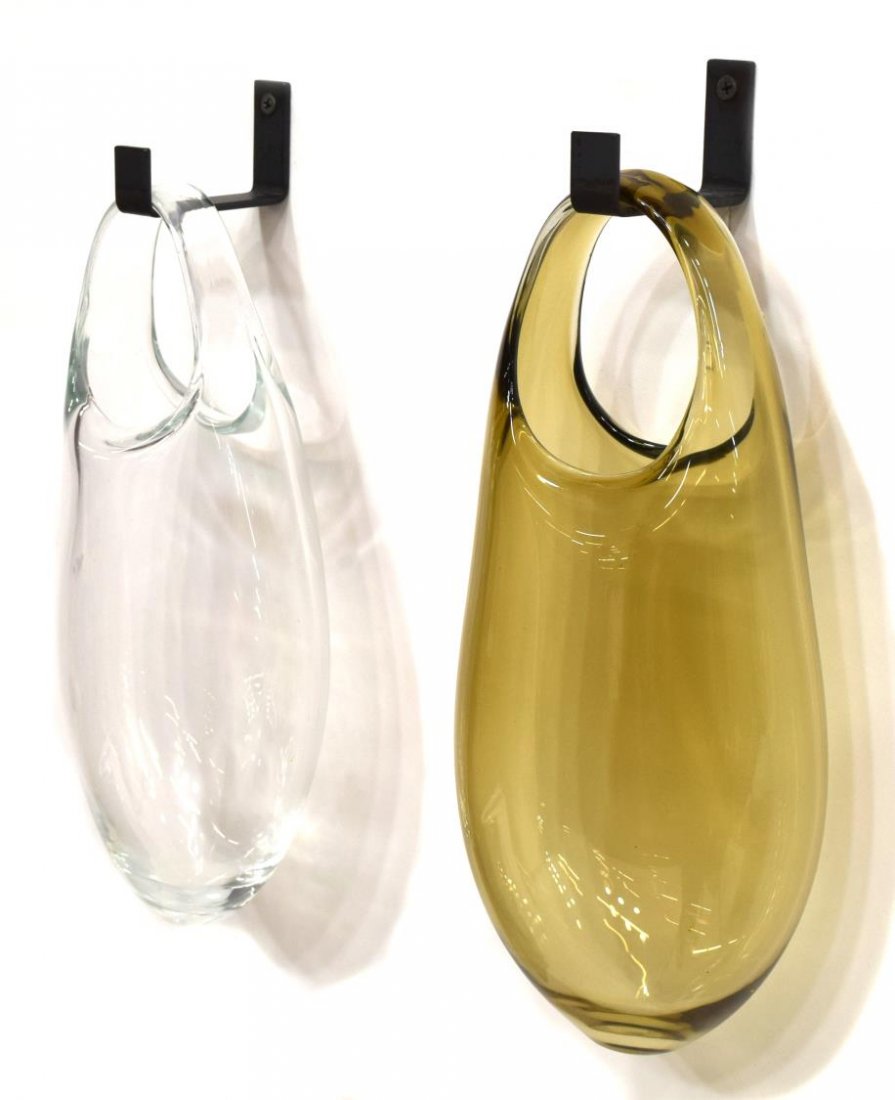 (2) MODERN SKLO HANGING ART GLASS WALL POCKETS: (lot of 2) Modern hanging blown art glass wall pockets, SkLo, "Hold Vessels", comprising (1) clear and (1) brown, each with a wall bracket, approx. 12.5"h, 5lbs Start Price: $80.00