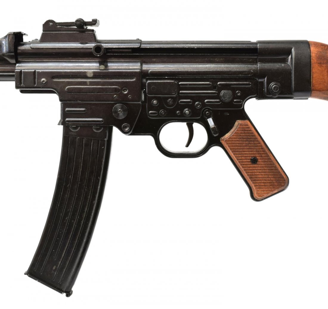 GERMAN MODEL 44 NON-FIRING PROP MACHINE PISTOL: German WWII Machine Pistol, Model 44, a non-firing prop made of black metal with wood grips and stock, 36.75"l *Provenance: Dispersal of the Blanco County WW2 Museum collection, Blanco, Texas.* Start 