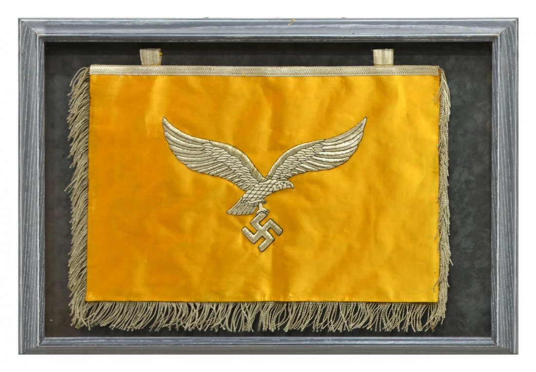 GERMAN WWII LUFTWAFFE FLYING EAGLE BANNER: Shadow box framed German WWII Luftwaffe banner, on one side the silver bullion embroidered flying eagle clutching a Nazi swastika in its' talons, the reverse side silver bullion German writing roughly