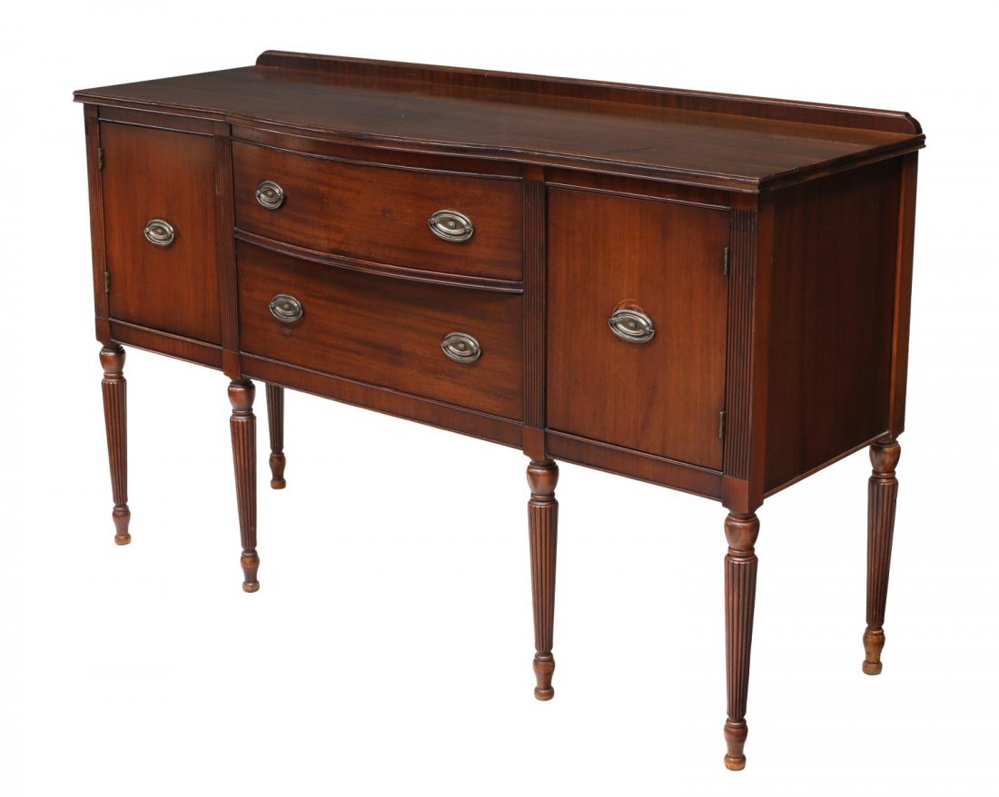 AMERICAN MAHOGANY SIDEBOARD: American mahogany sideboard, c.. 1950, a shaped rectangular top with short back rail and bowed center section over two drawers, flanked at each side by doors, rising on tapered ribbed supports, 37.75"