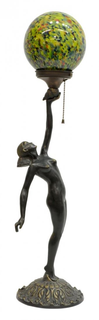 ART DECO PATINATED METAL FIGURAL TABLE LAMP: Art Deco style patinated metal figural table lamp, the green glass orb shade above the nude female figure rising on a shell and foliate base, 26.5"h, 7" diam., 8.5 lbs Start Price: $80.00