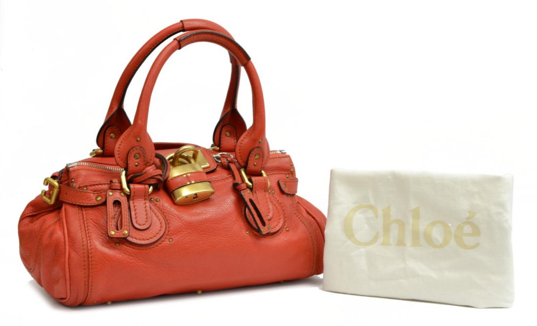 CHLOE 'PADDINGTON' ORANGE GRAIN LEATHER HANDBAG: Chloe "Paddington" in orange grained leather with brushed gold tone and silver tone hardware, two exterior slot pockets, top unzips to black cloth lined interior, with slot and zipped pockets, on smal