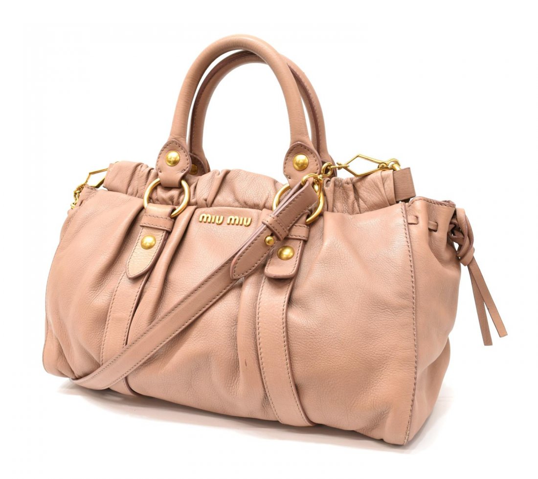 MIU MIU VITELLO LUX PINK CALF LEATHER BAG: Miu Miu "Vitello Lux" cross body bag in light pink leather, with two top handles, gold tone hardware, the snap closure top opening to single zipper compartment, bag: approx. 9.5"h, 13"w, 6"d, 1.5lbs S