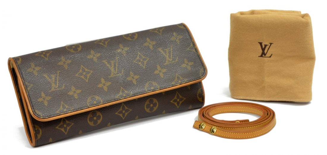 LOUIS VUITTON 'TWIN GM' MONOGRAM CANVAS HAND BAG: Louis Vuitton "Twin GM" clutch in monogram canvas, detachable leather hand or shoulder strap, fold over top unclasps to tan interior, accompanied by dust bag, patination, bag: approx. 4.75"h, 9.5"w, 1