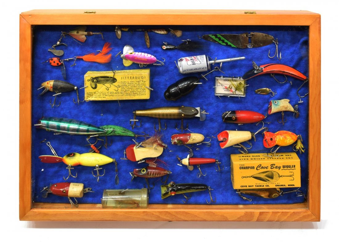 (29) VINTAGE FISHING LURES IN WOOD DISPLAY BOX: (lot of 29) Vintage fishing lures including wood, glass eyes, Arbogast Jitterbug with box, Champion Wiggler by Cove Bay with with box, all housed in wood box with hinged glass door, approx: 2.75"h, 20