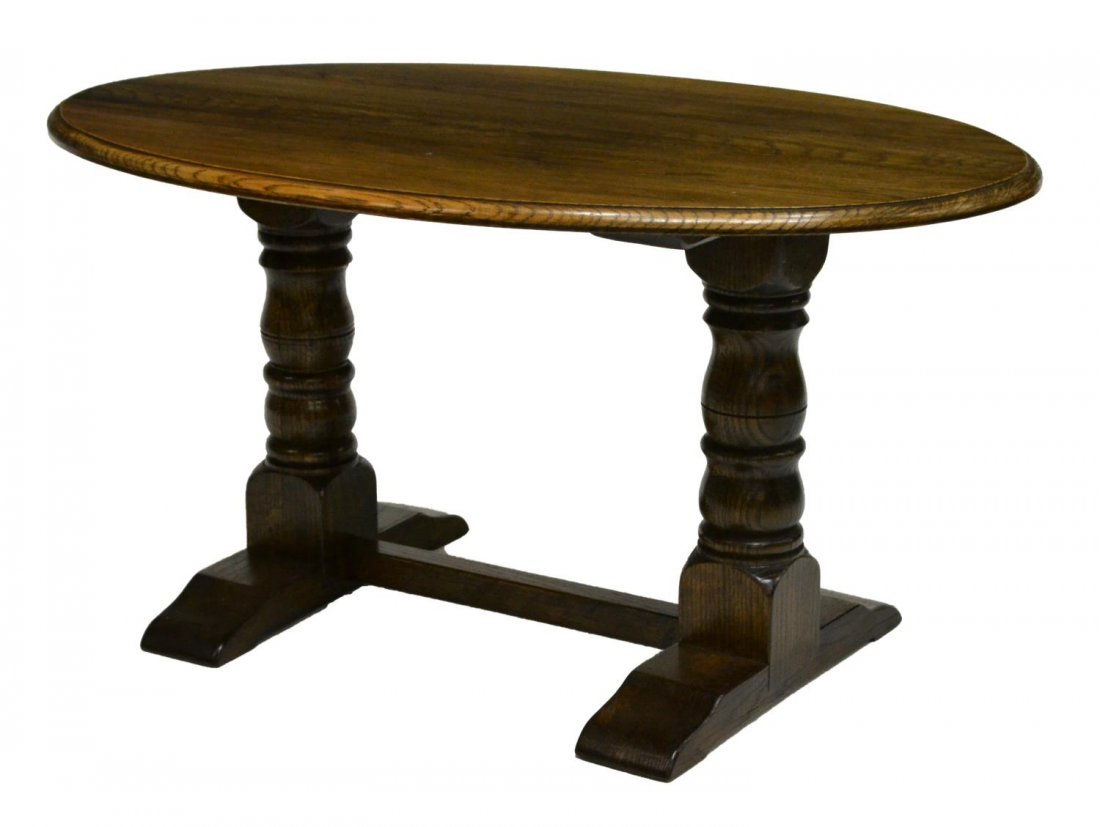 DIMINUTIVE ENGLISH OAK TRESTLE BASE COFFEE TABLE: English oak coffee table, the oval top rising on a trestle base, 18.25"h, 35.5"w, 23.25"d Start Price: $60.00