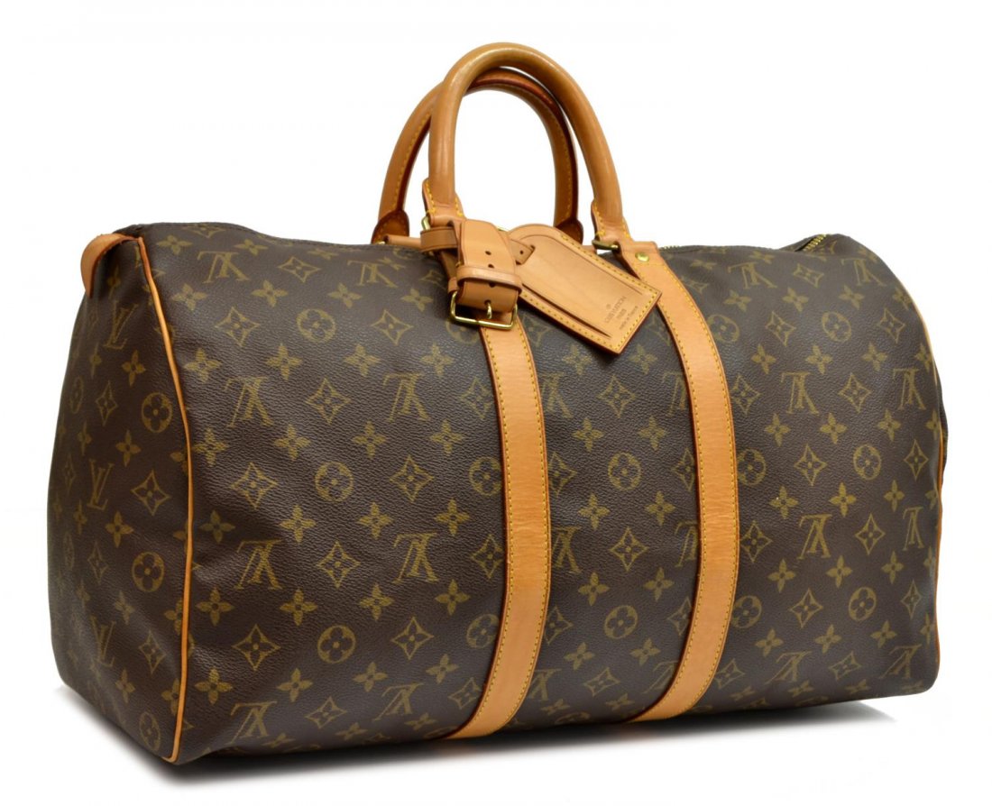 LOUIS VUITTON 'KEEPALL 45' MONOGRAM DUFFLE BAG: Louis Vuitton "KeepAll 45" traveling duffle bag in monogram canvas, having leather handles, piping and trim, gold tone hardware, zip top opens to brown canvas lined interior, retaining luggage tag, ha
