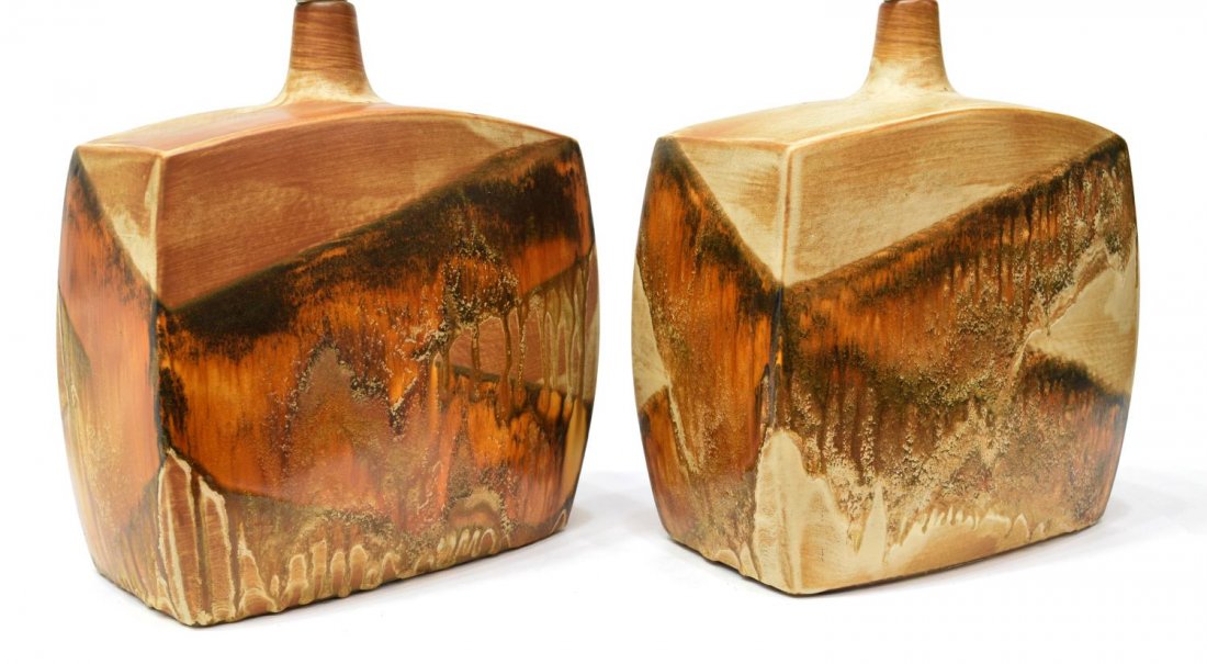 (2) MID-CENTURY MODERN GLAZED EARTHENWARE LAMPS: (pair) Mid-century modern glazed earthenware table top lamps, each having a single light above squared body, accompanied by harps, 15"h, 10"w, 6.5"d, 19lbs Start Price: $80.00