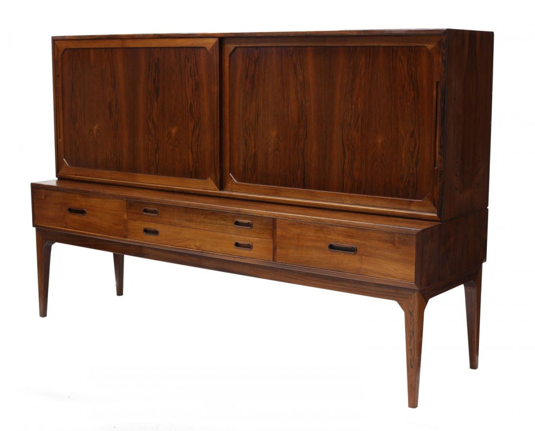DANISH MID-CENTURY MODERN ROSEWOOD SIDEBOARD: Danish mid-century modern rosewood sideboard, c. 1960, the upper part with two sliding doors revealing shelved storage and pull out trays, the lower part with four doors, rising on tapered squared sup