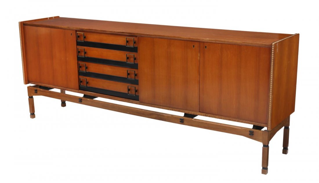ITALIAN MID-CENTURY MODERN TEAKWOOD SIDEBOARD: Italian mid-century modern teakwood sideboard, the rectangular case accented with carved borders, over four black leather trimmed drawers with square metal pulls, flanked by single door and double doo