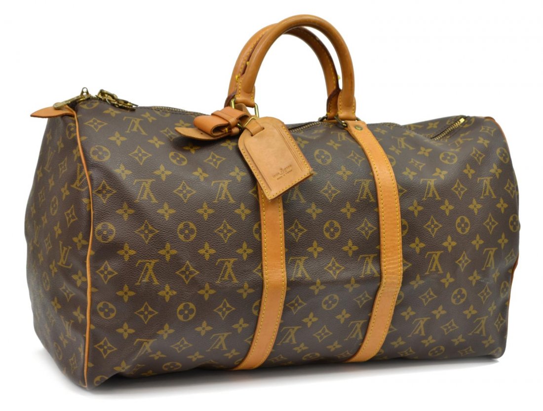LOUIS VUITTON 'KEEPALL 50' MONOGRAM DUFFLE BAG: Louis Vuitton "KeepAll 50" traveling duffle bag in monogram canvas with leather trim, zipped top opening to canvas interior, retaining shoulder strap, luggage tag, handle strap, lock and key, patinati