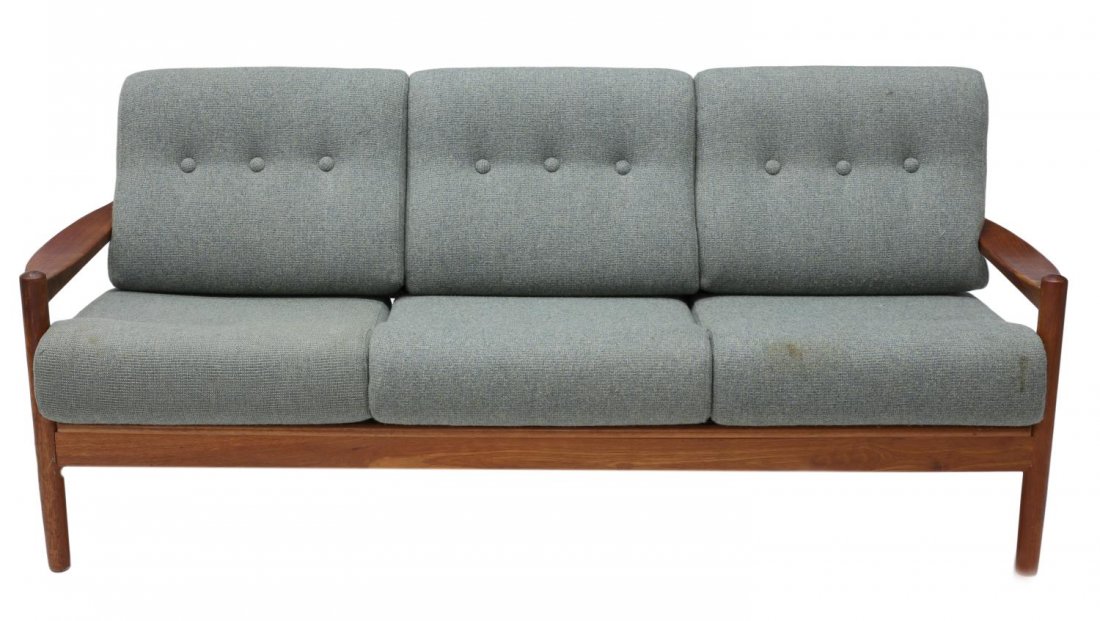 DANISH MID-CENTURY MODERN TEAK THREE-SEAT SOFA: Danish mid-century modern teakwood open arm sofa, 1950s/1960s, having removable back and seat cushions over the teakwood frame, with flat armrests, rising on cylindrical legs, some stains to upholster