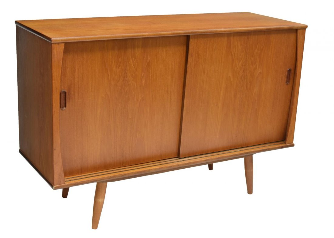 DANISH MID-CENTURY MODERN TEAKWOOD SIDEBOARD: Danish mid-century modern teakwood sideboard, 1950's, having two sliding doors, storage shelves and drawers, rising on turned tapered supports, 32.5"h, 48"w, 17.5"d Start Price: $250.00