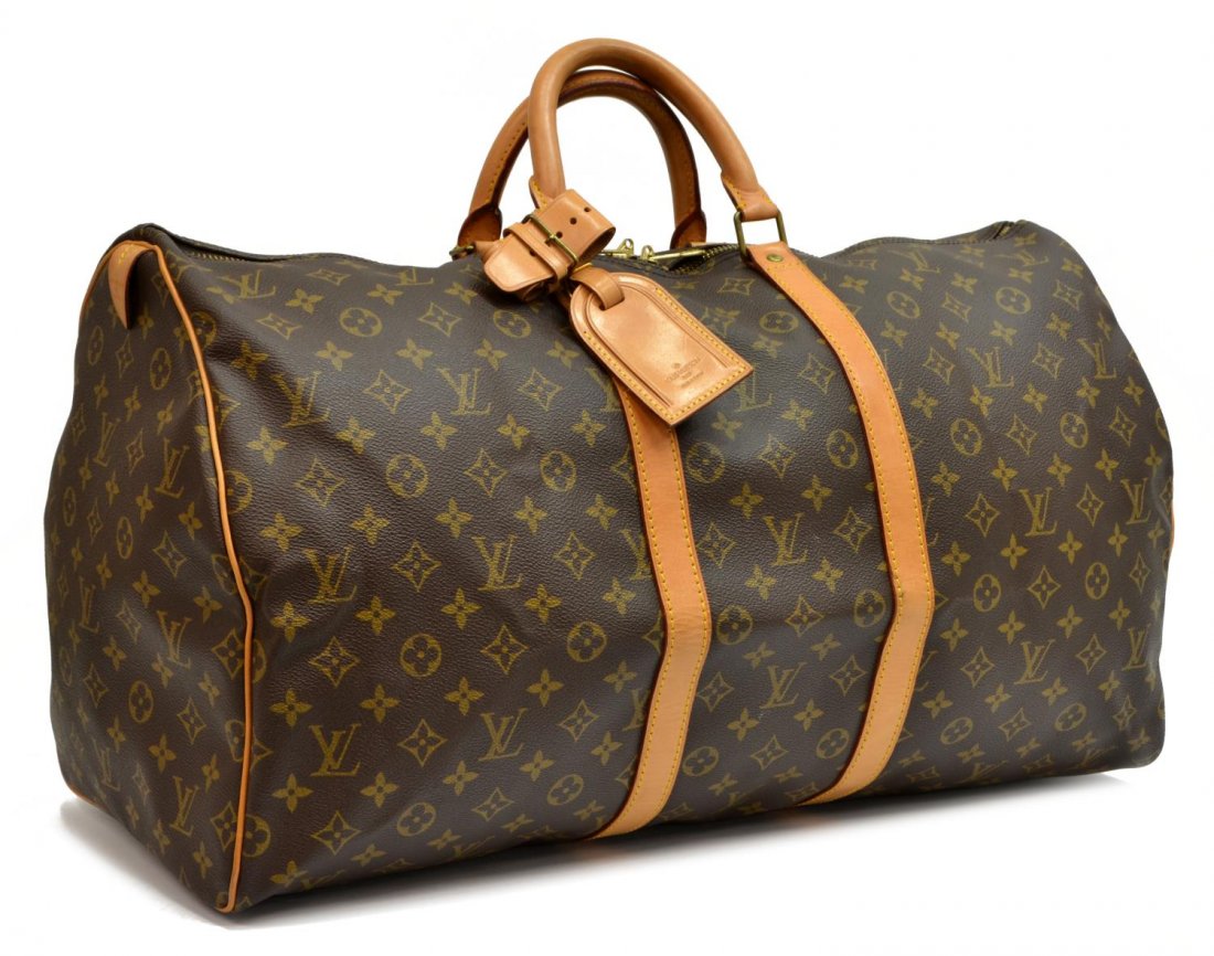 LOUIS VUITTON 'KEEPALL 55' MONOGRAM DUFFLE BAG: Louis Vuitton "KeepAll 55" traveling duffle bag in monogram canvas, having leather handles, trim, and piping, gold tone hardware, zip top opening to brown fabric lined interior, retaining luggage tag 