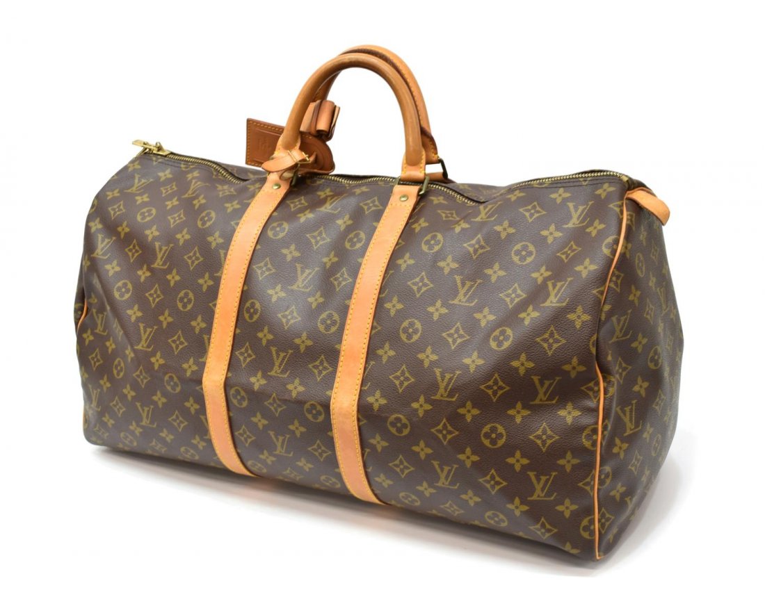 LOUIS VUITTON 'KEEPALL 55' MONOGRAM DUFFLE BAG: Louis Vuitton "KeepAll 55" traveling duffle bag in monogram canvas, having leather handles, trim, and piping, gold tone hardware, zip top opening to brown fabric lined interior, retaining luggage tag 