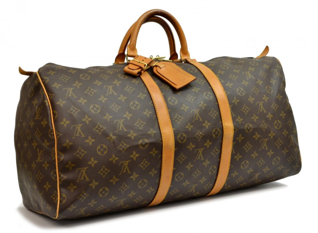 LOUIS VUITTON 'KEEPALL 55' MONOGRAM DUFFLE BAG: Louis Vuitton "KeepAll 55" traveling duffle bag in monogram canvas, having leather handles, trim, and piping, gold tone hardware, zip top opening to brown fabric lined interior, retaining luggage tag 