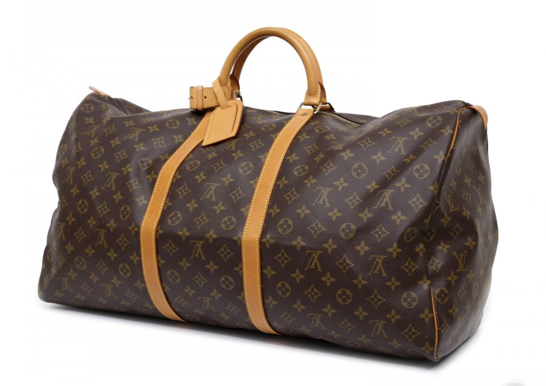LOUIS VUITTON MONOGRAM 'KEEPALL 60' DUFFLE BAG: Louis Vuitton "KeepAll 60" traveling duffle bag in monogram canvas, leather piping and trim, zip top opens to canvas interior, retaining luggage tag, handle strap, lock and key, patination and some sp