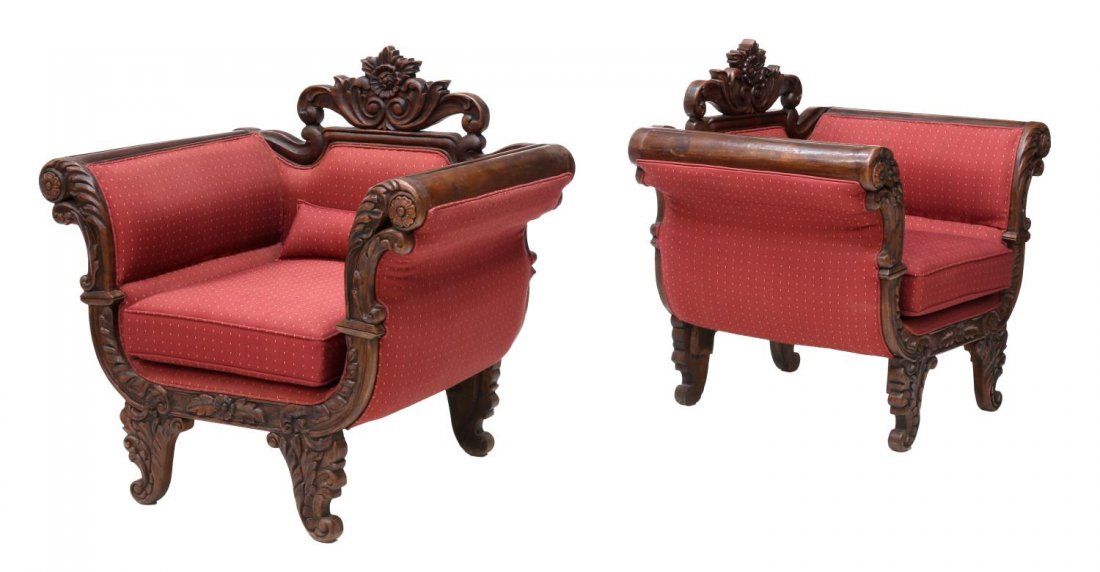 (2) FRENCH COLONIAN CARVED TEAKWOOD CHAIRS: (pair) French Colonial carved teakwood parlor chairs, each having a pierced foliate crest scrolling down into arms with rosette handholds and acanthus leaf supports, upholstered paneled back, over rem