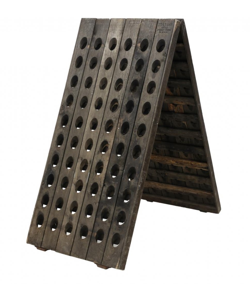 FRENCH FOLDING WINE BOTTLE RACK BY STE LEBAN: Rustic French folding wooden wine bottle rack, with insiced brand upper right corner, "Ste Leban Fabricant Epernay, France", sixty oval reserves on each side, 59"h, 28.5"w, 49"d Start Price: $300.00