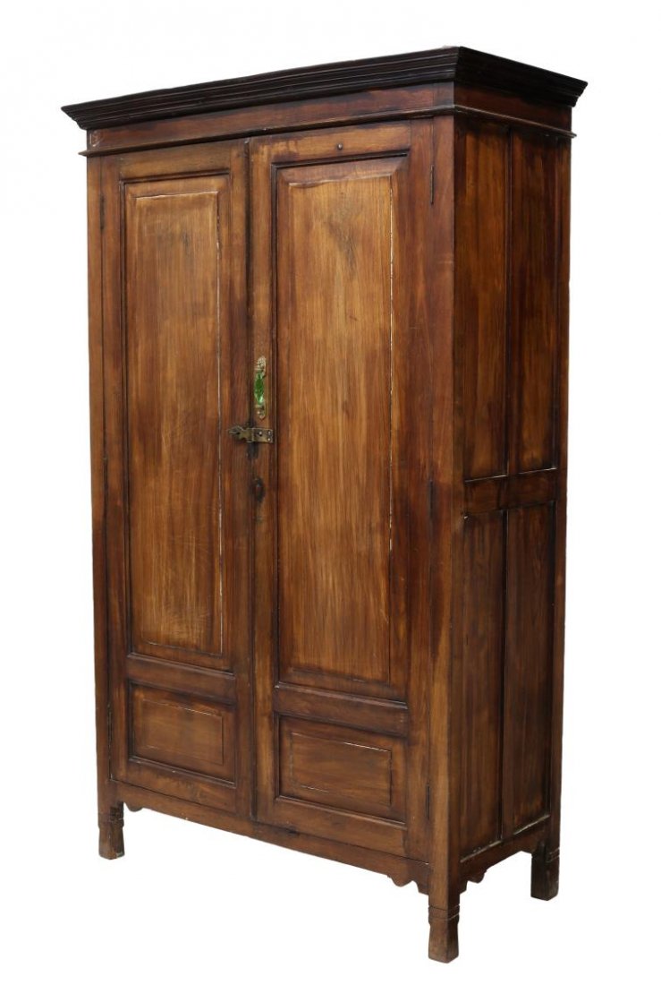 FRENCH COLONIAL TWO-DOOR ARMOIRE, 20TH C.: French colonial two-door armoire, 20th c., the corniced top over the recessed panel case, fitted with two doors, opening to shelved interior, rising on squared feet, brass latch closure, later gilt me