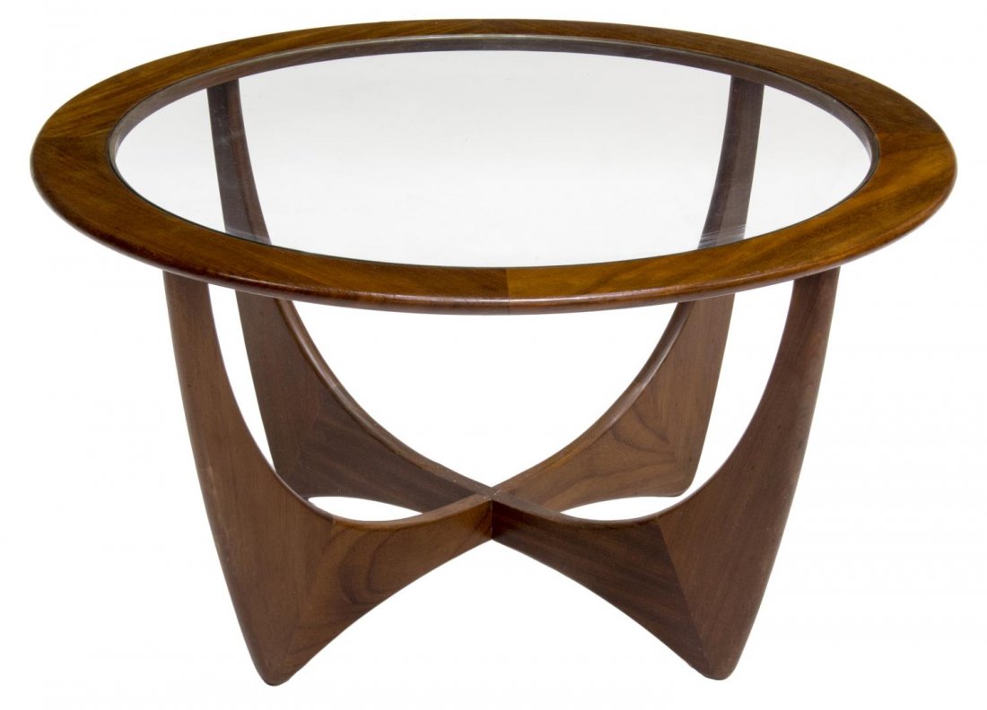 MID-CENTURY MODERN TEAKWOOD & GLASS COFFEE TABLE: Mid-Centruy modern teakwood coffee table, c. 1960, the circular top set with clear glass panel, over tapered legs with joined support, 18"h, 33" diam Start Price: $60.00