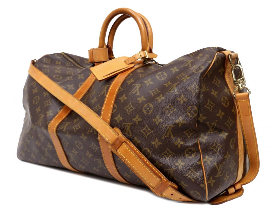 LOUIS VUITTON 'KEEPALL 50' MONOGRAM DUFFLE W/STRAP: Louis Vuitton "Keepall 50" traveling duffle bag in monogram canvas, having leather handles, trim, and piping, zipped top opening to brown canvas lined interior, retaining luggage tag, handle strap, lo