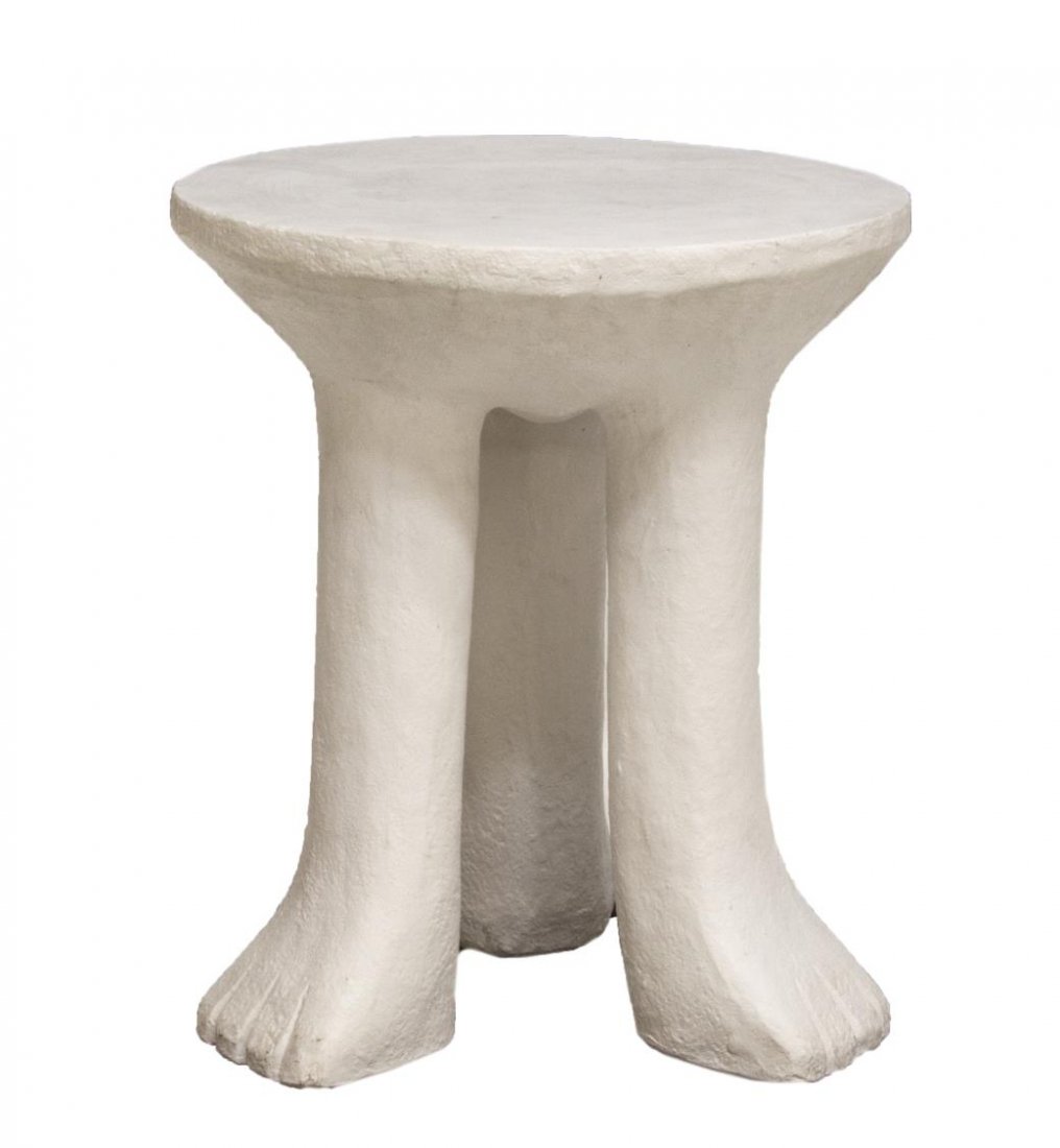 "AFRICAN TABLE" IN THE MANNER OF JOHN DICKINSON: "African Table" a reproduction in the manner of John Dickinson (California, 1920-1982), in white plaster like finish, the circular top rising on three elephant like feet, approx. 23.5"h, 20" diameter