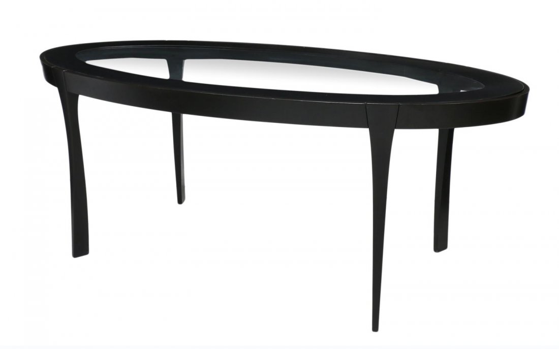 ITALIAN MODERN DINING TABLE: Italian modern dining table, c. 1960, an oval top framed with black acrylic surrounding the inset glass, rising on shaped black legs, 29.25"h, 77"l, 39"d Start Price: $150.00