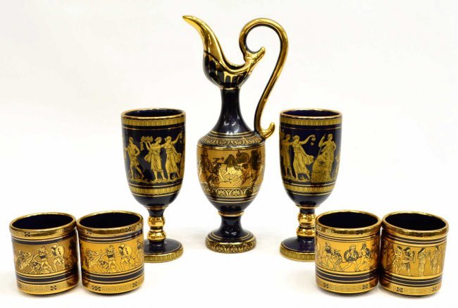 SPYROPOULOS GREEK CLASSICAL GILT EWER & GLASSES: (set of 7) Spyropoulos ceramic drink service, Greece, 24 K gold and deep blue ground, Classical scenes and geometric motif, comprising: (2) water goblets, 7.25"h; (4) cups, 3.25"h; (1) pitcher, 11.75"