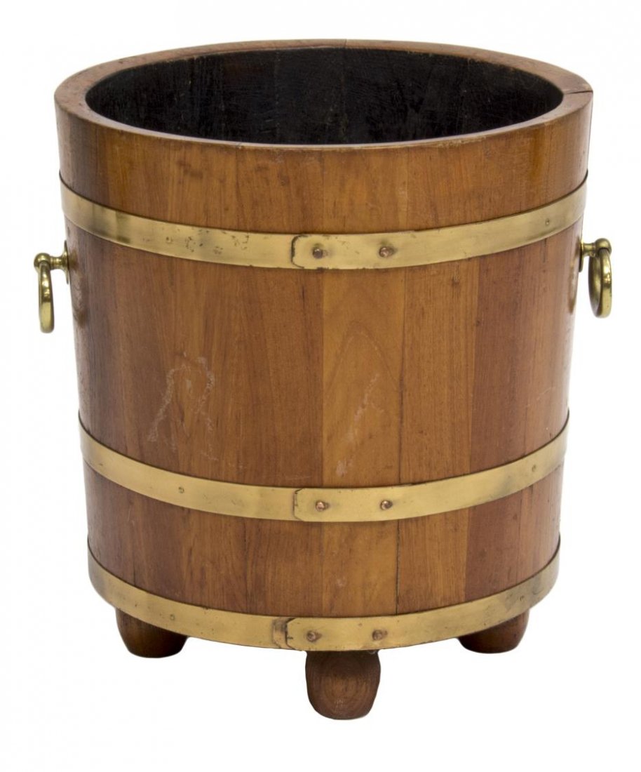 ENGLISH MAHOGANY & BRASS BANDED BARREL: English mahogany and brass banded barrel, 20th c. having ring handles at sides, rising on tapered ball feet, 17.75"w, 16" diam Start Price: $60.00