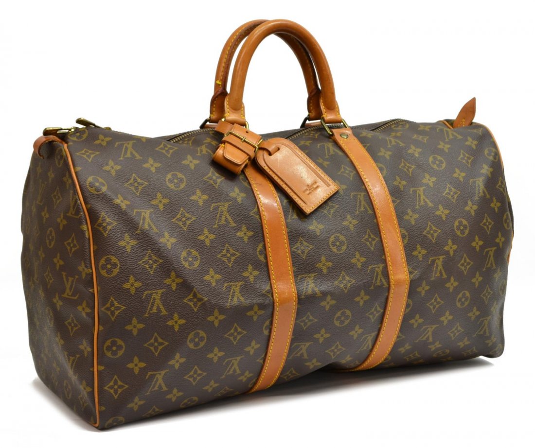 LOUIS VUITTON MONOGRAM 'KEEPALL 50' DUFFLE BAG: Louis Vuitton "Keepall 50" traveling duffle bag in monogram canvas with leather handles, piping and trim, zipped top opening to brown canvas interior, retaining luggage tag, handle strap, patination, 
