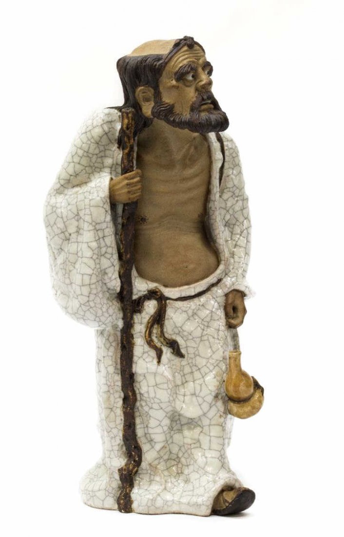CHINESE CELADON FINISH FIGURAL MAN & STAFF: Chinese ceramic figure in a crackled celadon glaze, old man in white robes holding staff, accented with a conical hat and calabash gourd vase, approx 13.75"h, 7.0"w, 6.5"d, 8.25lbs Start Price: $50.00