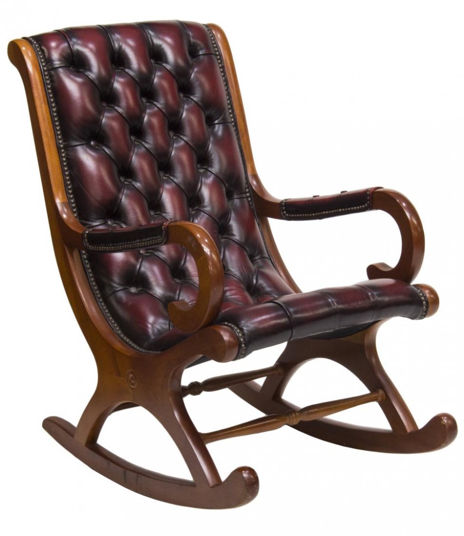 ENGLISH 'CAMPECHE' OXBLOOD LEATHER ROCKING CHAIR: English "Campeche" oxblood leather armchair rocker, c. 1970, the angled backrest above padded arms with scroll form supports, over the tufted leather upholstery with nail head trim, rising on stretche