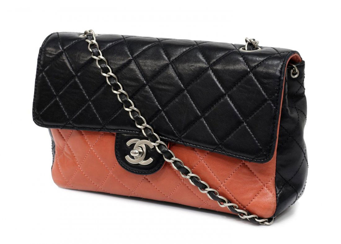 CHANEL SALMON & BLACK QUILTED LEATHER FLAP BAG: Chanel black quilted leather flap bag having salmon front panel and lined flap, silver tone woven leather chain and leather shoulder strap, exterior slot pocket, CC logo turnlock, zipped pocket to the