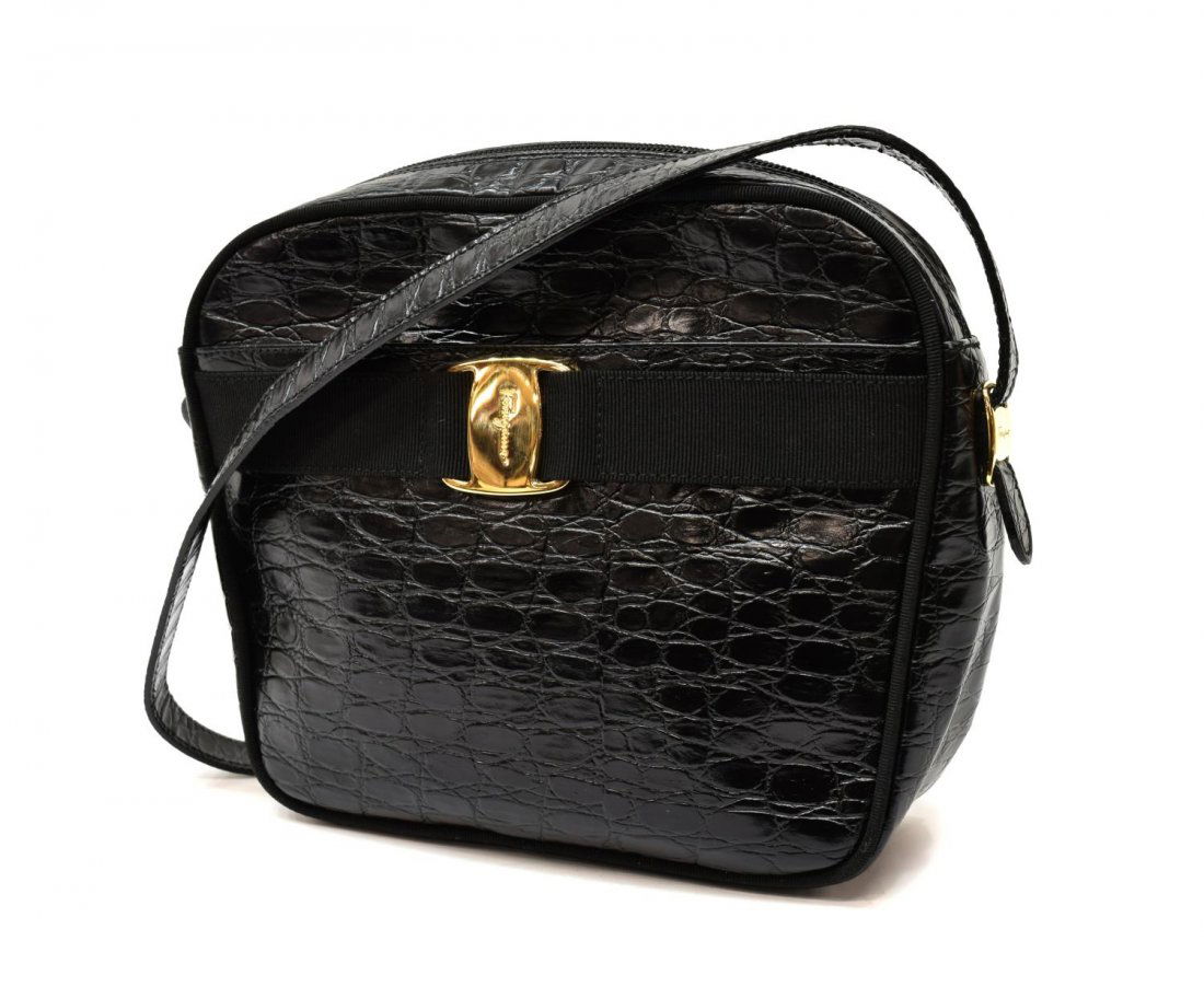 FERRAGAMO BLACK CROCODILE LEATHER BAG: Ferragamo black crocodile leather bag, having a long adjustable shoulder strap, gold tone hardware, with a slot pocket at front, zip top opening to fabric lined interior with single zipper pocket, bag