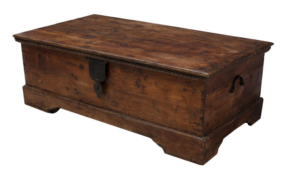 LARGE DUTCH COLONIAL CARVED WOODEN DOWRY CHEST: Large Dutch Colonial carved teakwood dowry chest, c. 19th century, Goa, India, the rectangular case over a triangular carved border, with iron hinge and lock, the rising on bracket feet and casters, 2