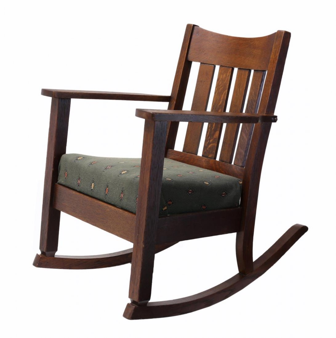 COCHRAN ARTS & CRAFTS ROCKING CHAIR, EARLY 20TH C.: Arts & Crafts oak rocking chair, Cochran Chair Company, Indiana, c. 1910, vertical back slats, the arms flanking a central removable cushion with springs, retaining the partial makers tag at underside