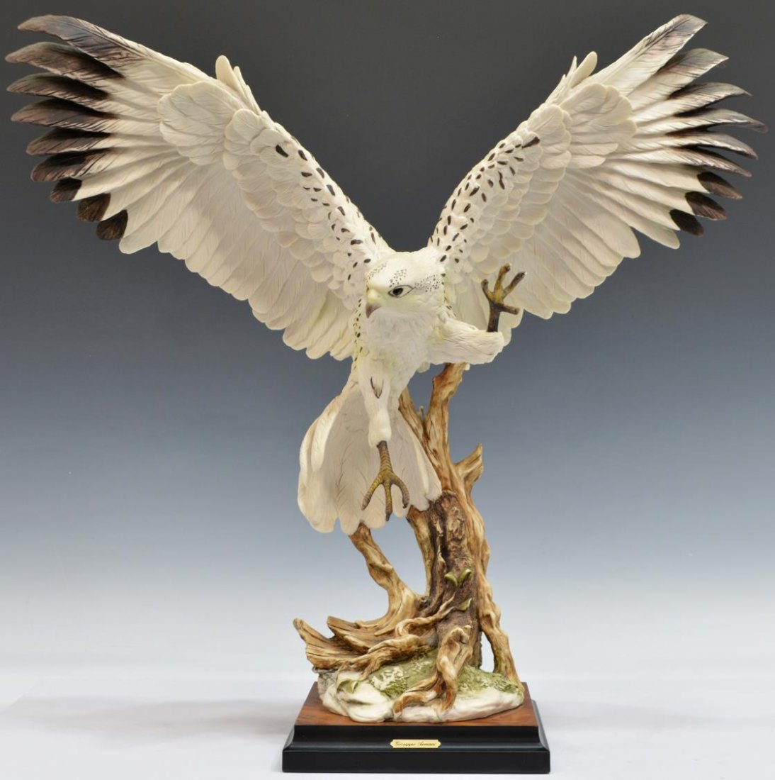 (2) ITALIAN G. ARMANI FIGURES, WHITE HAWK & CLOWN: (lot of 2) Italian Giuseppe Armani (1935-2006) figures: (1) standing clown; (1) large flying white hawk, talons extended,1988, 21"h, 21.5"w, 7"d, ; both marked on back, rising on a wooden base, larges