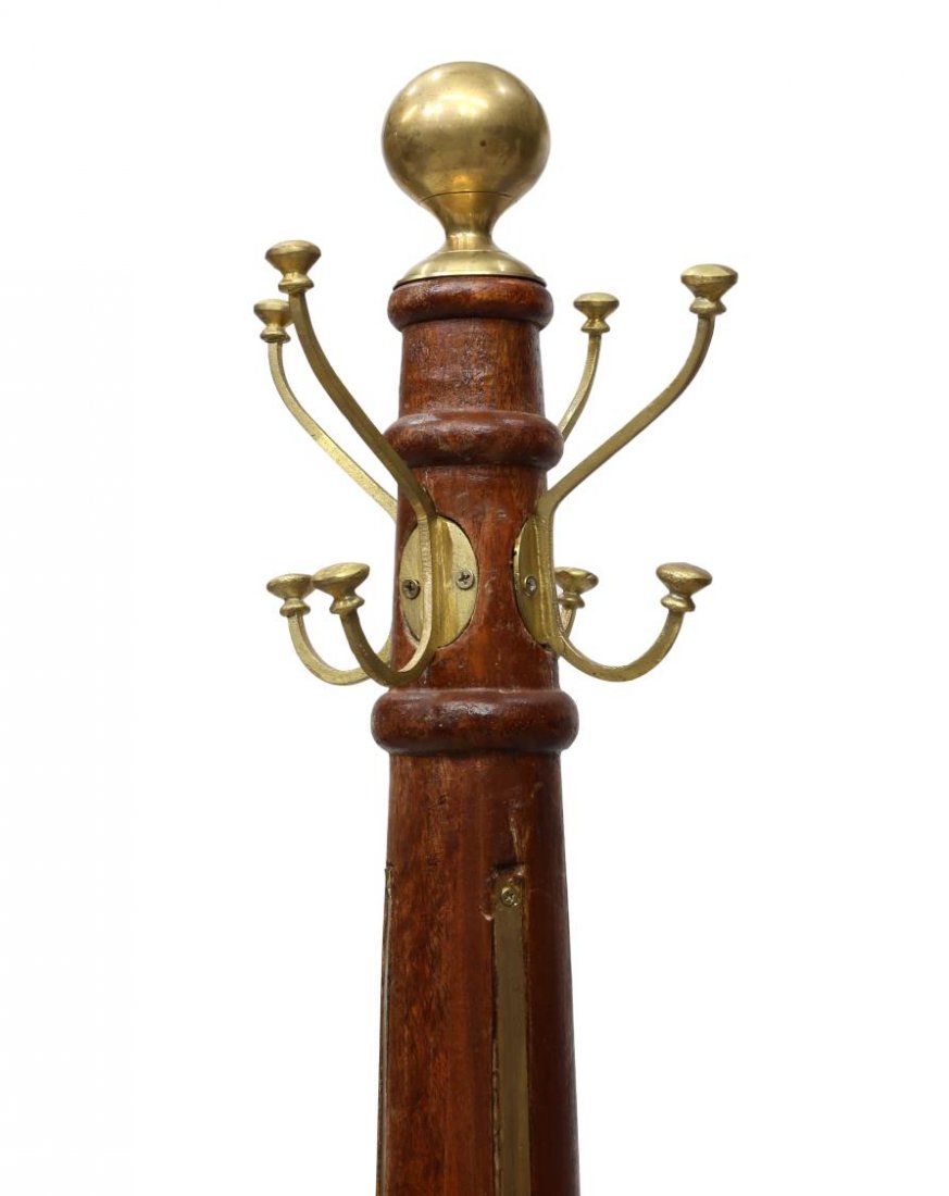 TALL TEAKWOOD & BRASS STANDING COAT /HAT RACK: Teakwood coat / hat stand, a brass ball and four hooks, surmount the cylindrical standard with inset brass straps, rising on four scrolled legs, approx 78.75"h Start Price: $150.00