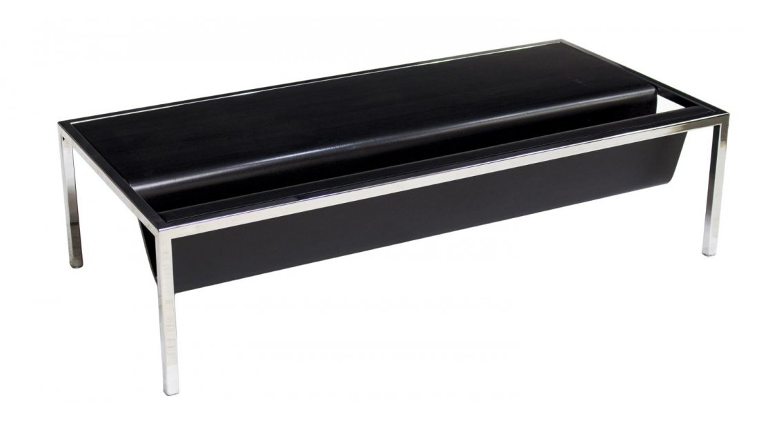NIENKAMPER MODERN COFFEE TABLE: Modern coffee table by Nienkamper, Toronto, a rectangular chrome steel frame with moulded black top having a shaped magazine rack, rising on squared supports, 14"h, 54"w, 26"d Start Price: $200.00