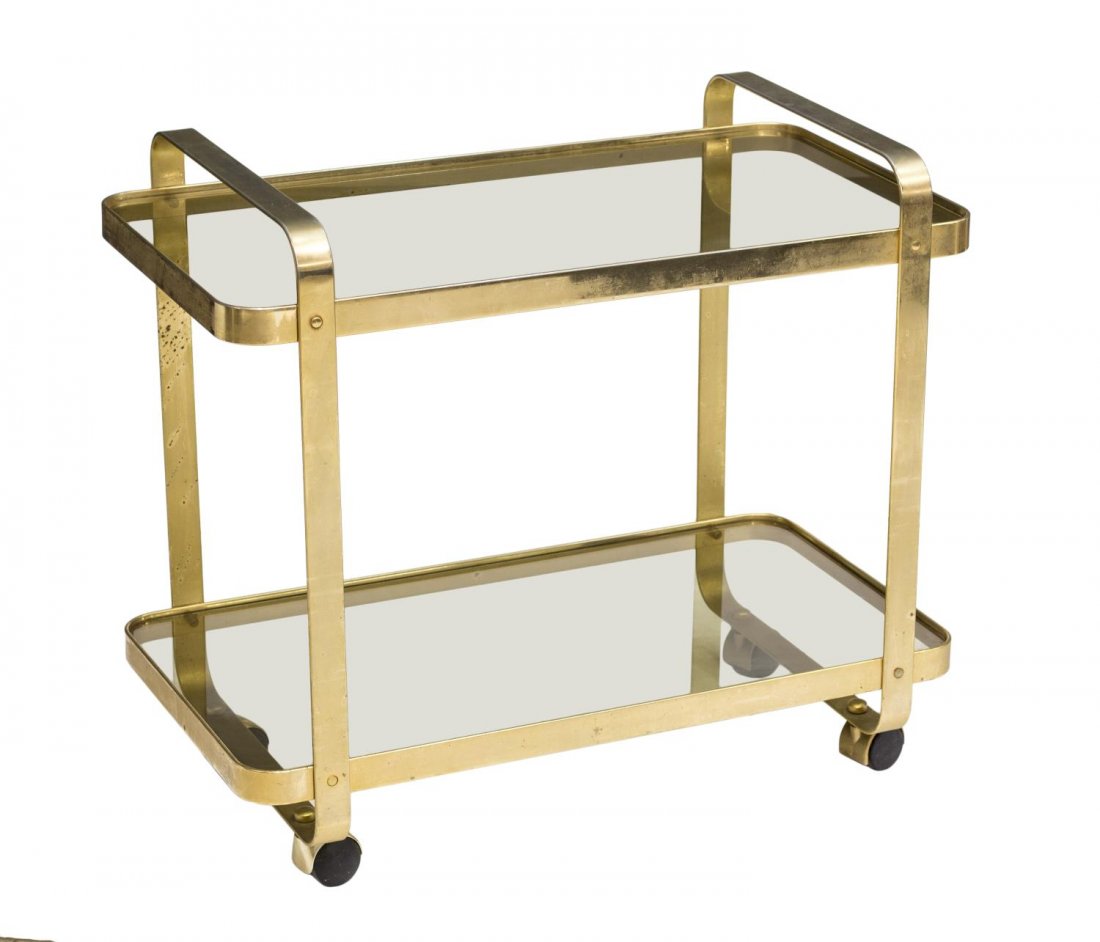 ITALIAN MID-CENTURY MODERN BRASS & GLASS CART: Italian mid-century modern brass service cart, c. 1960's, having two tiers inset with smokey glass, rolling on round wheels, some loss to finish, patination, 26.5"h,30"l, 16"w Start Price: $100.00