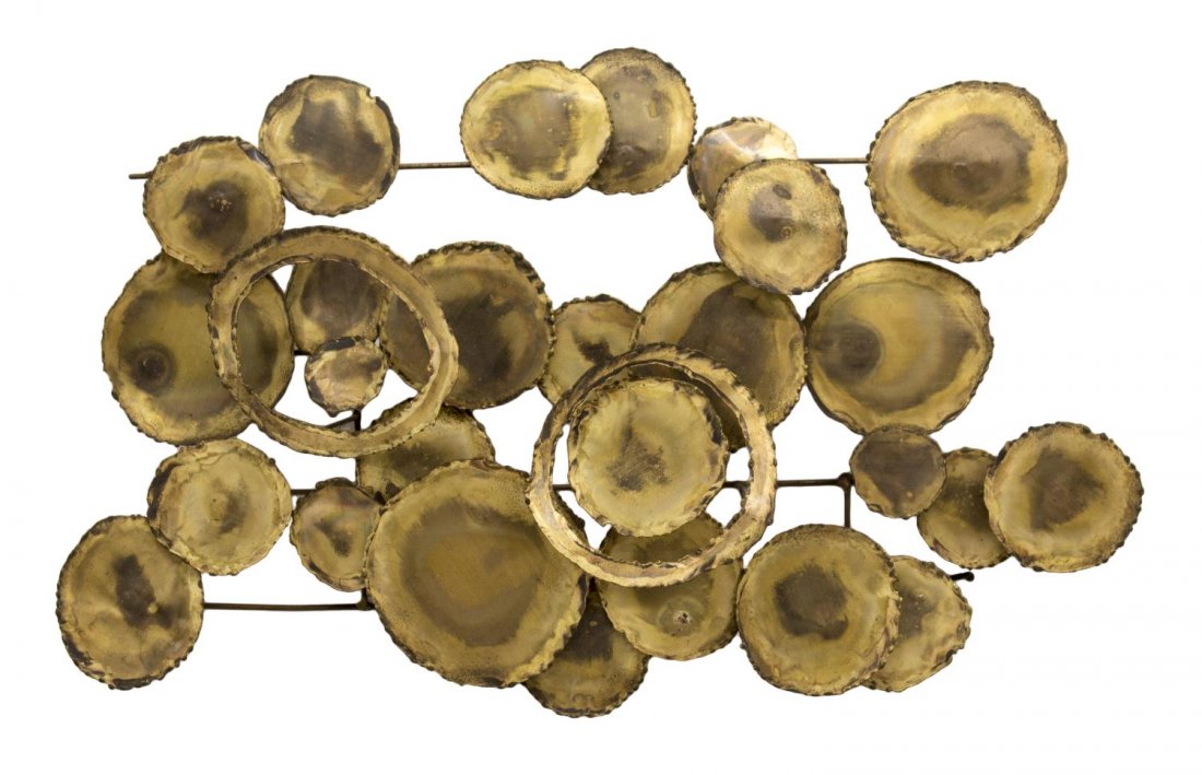 MID-CENTURY MODERN BRASS WALL SCULPTURE C JERE: Mid-century modern brass wall sculpture in the style of Curtis Jere, c. 1960's, composed of three dimensional rough edge circular discs, 14"h, 22"w, 5"d Start Price: $60.00