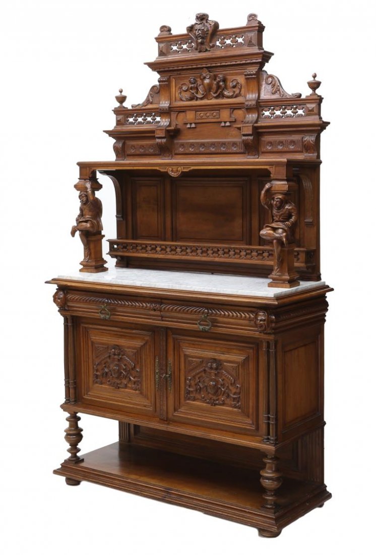 FRENCH HENRI II HEAVILY CARVD MARBLE TOP SIDEBOARD: French Renaissance Revival Henri II heavily carved marble top sideboard, 19th c., the figural crest over shield and acanthus scrolls, flanked by turned finials, over a pierced frieze, the top shelf ab